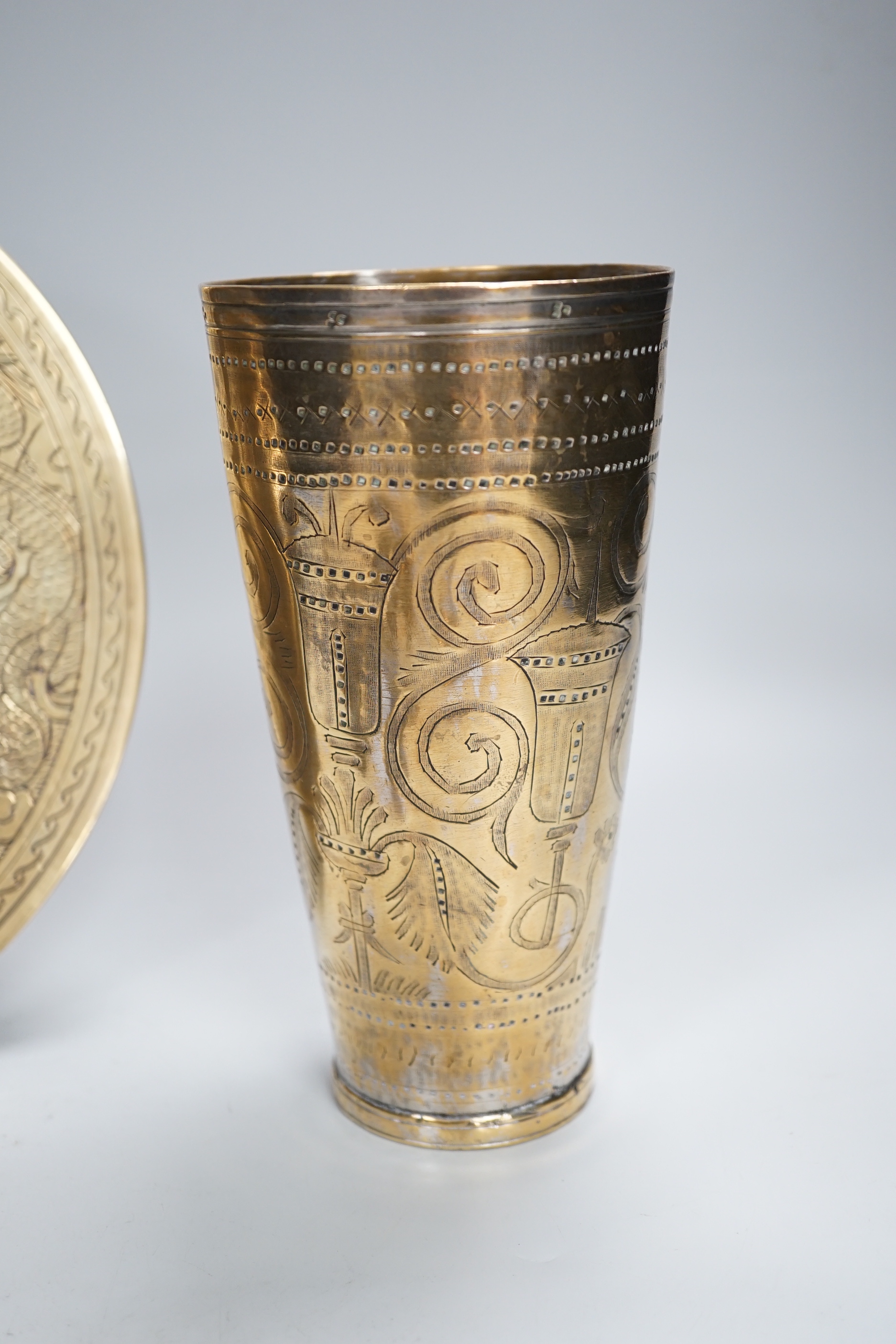 A Chinese engraved brass plate, large engraved beaker, koi fish and a dragon, the largest 24cm in diameter